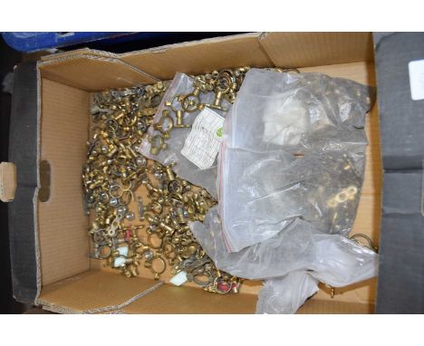 Box containing a large quantity of brass single ring fixings