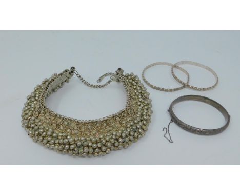 A white metal articulated Indian Bell charm ankle bracelet and matching bangles along with a Victorian style silver engraved 
