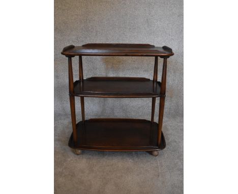 A vintage elm Ercol drinks trolley with three tiers on casters. H.77 x W.72cm 