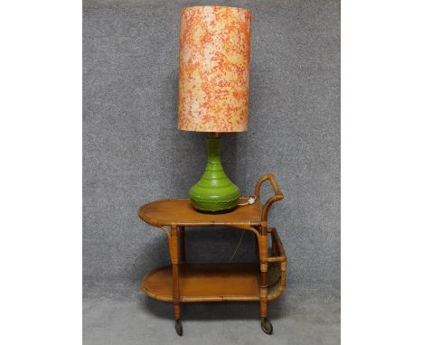 A 1970's vintage green glazed table lamp on vintage wicker drinks trolley H.70 W.73 D.46cm 