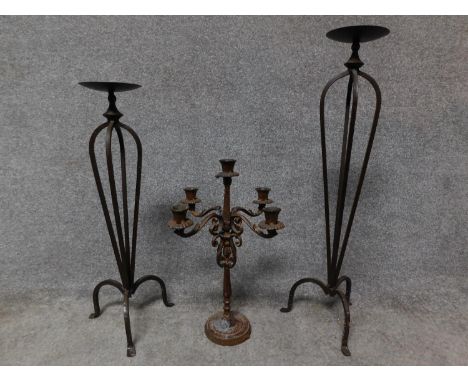 A wrought iron floor standing pricket candlestick, another similar and a table candelabra. H.78cm 