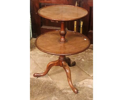 A George III mahogany two tier dumbwaiter, circa 1820, gradual circular shelving with moulded edge, turned column, raised on 