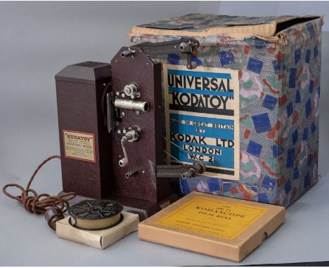 A boxed 1930's Universal Kodatoy projector, with a Felix the Cat/Charlie Chaplin film, Art Deco graphics