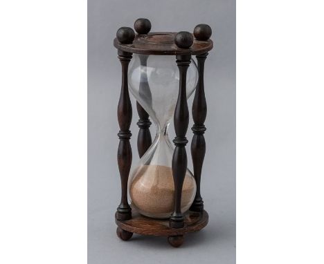A 19th Century 8 minute desk timer, mounted in a turned rosewood stand with baluster spindles, height 17cmCondition: one end 