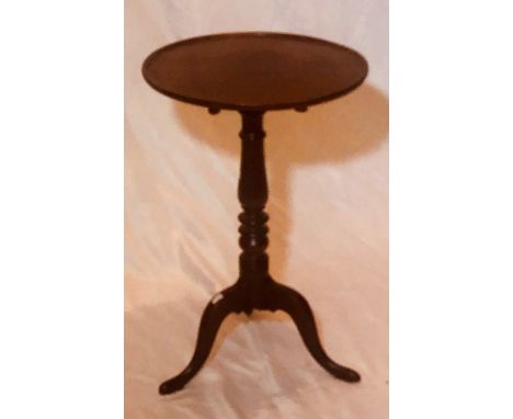 An early 19th Century oak wine table, circular moulded top on a turned column, raised on tripod form cabriole legs with acant