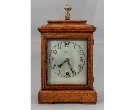An Edwardian oak cased bracket timepiece, caddy top with metal handle, silvered dial, height 26cm, (pendulum)&nbsp;