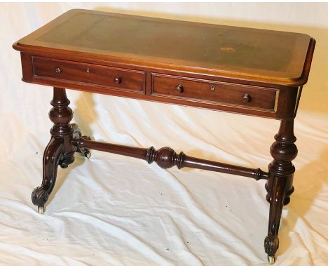 An early Victorian mahogany library table, circa 1860, moulded top with leather inlay, above two frieze drawers with identica