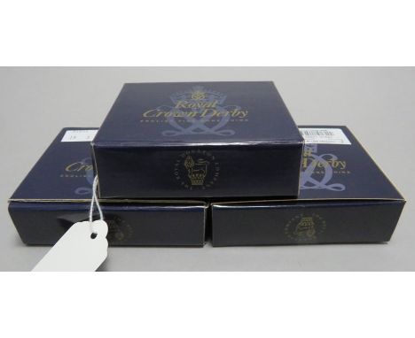 A group of three Royal Crown Derby limited edition Christmas ceramic decorations in original boxes. To include a tree, a wrea