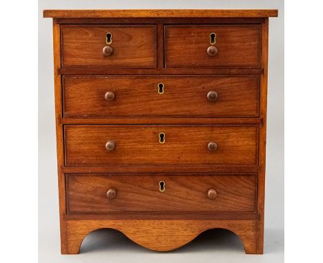 A 19th Century mahogany miniature or apprentice chest of drawers, two short over three long drawers with turned pulls, shaped