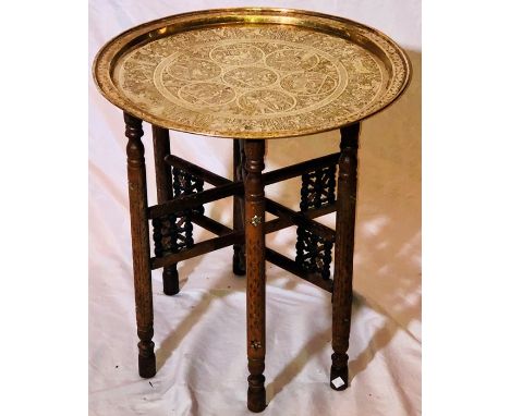 A large Egyptian brass tray top table, decorated engraving, folding hardwood mother of pearl inlay base. 57cm H x 55cm WCondi