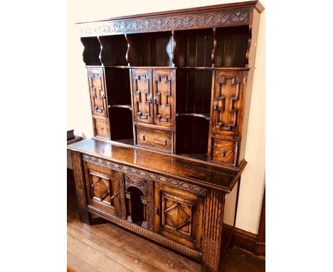 A 17th Century Jacobean revival welsh oak dresser, moulded cornice on a foliage decorated frieze, above a shelf with scrollin