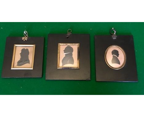 Three 19th Century silhouette portrait profile miniatures, comprising boy wearing a ruff and two gentlemen, black lacquer fra