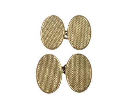 A pair of 9ct gold cuff links - oval with an engine turned finish, 4.1g.