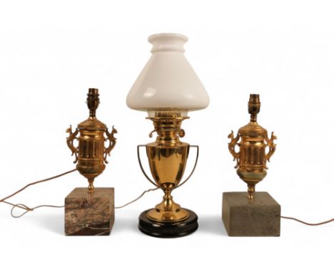 A pair of brass and marble table lamps - raised on square marble bases, together with another table lamp converted from an ea
