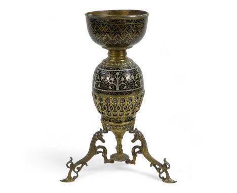 An early 20th century Turkish brass and enamel lamp base - decorated with foliage and flowers on a lattice ground, on a tripo