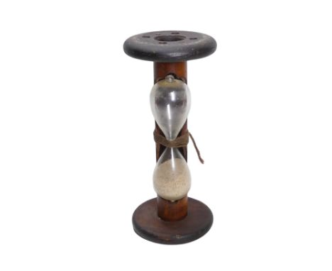 An egg timer formed from a spinning bobbin - runs to three minutes, 24cm high.