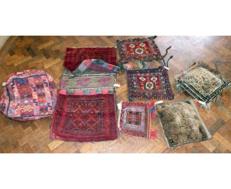 Two Asian saddle bags with three cushions and pouffe. No condition reports for this sale.