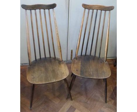 Pair of high back Ercol dining chairs. No condition reports for this sale.