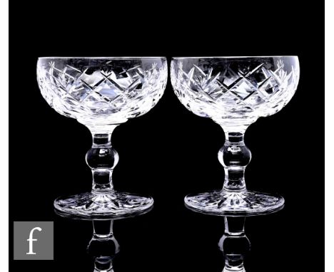 A group of twelve Waterford crystal Donegal pattern coupe glasses on knopped stems, most with acid etched marks, height 11cm.