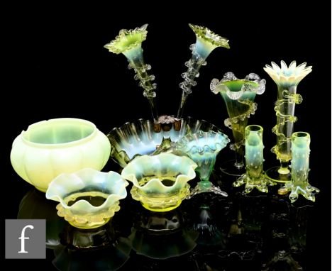 A collection of Victorian uranium vaseline glass, to include a table epergne with three glass trumpets on circular frilled ba