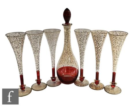 A 20th Century continental decanter set comprising a skittle form decanter with six tall fluted with a low knopped base, the 