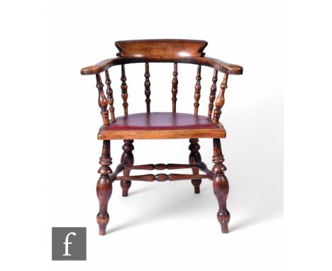 A 19th Century smoker's bow elbow chair, red leather and brass studded seat, on turned legs.
