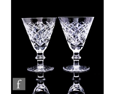 A group of eight Waterford crystal Adare pattern wine glasses with flared bowls on flat knopped stems, most with acid etched 