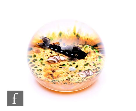 A contemporary William Manson glass paperweight, of domed form, internally decorated with a stylised lamp work fish, over a s