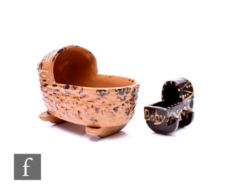 A Whieldon style earthenware cradle, of traditional form on bowed rockers and tortoiseshell glaze, length 10cm, and a smaller