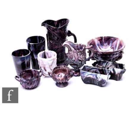 A collection of late Victorian amethyst Malachite pressed glass, including Heppell &amp; Co fish jug, two Sowerby vases, Sowe