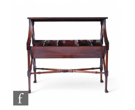 An early 20th Century mahogany floor standing book shelf, with a five divisional trough below, with downswept supports on tur