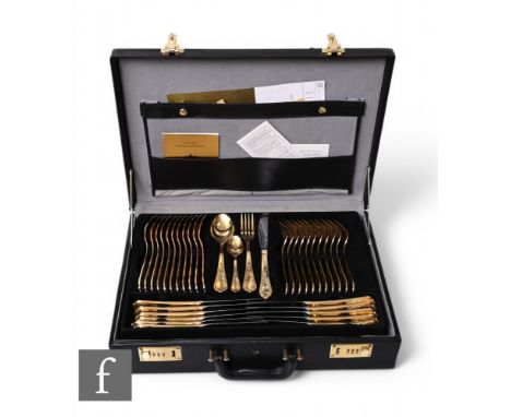 A German SBS Bestecke Solingen gold plated canteen of cutlery for eleven settings, in a fitted black leather briefcase with b