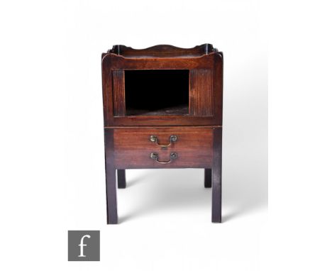 A George III mahogany square commode, the tray top over a sliding door and false drawers with sliding tambour front on square