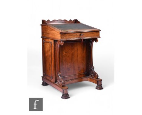 A William IV rosewood Davenport, the interior fitted with four short drawers enclosed by a green leather inset fall, with pul