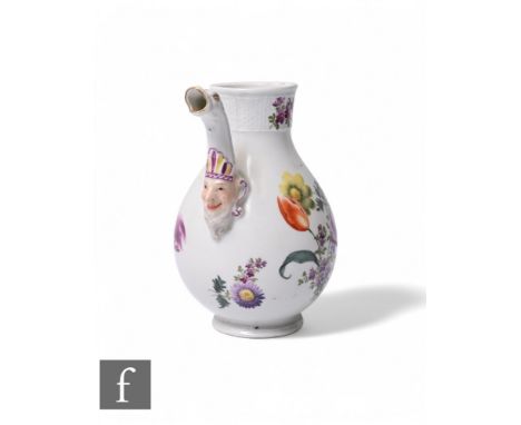 A Meissen porcelain milk jug, of baluster form with mask and sea serpent spout decorated with floral sprays and sprigs over w