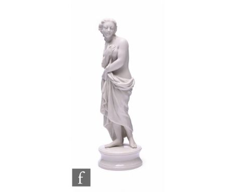 A Belleek figure, modelled as a classical semi-robed female figure on circular socle base, unmarked, height 31cm.