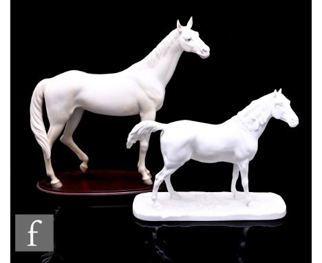 A Lladro bisque porcelain figure of a Thoroughbred Dappled Horse, modelled standing with hind leg raised, on stepped oval woo