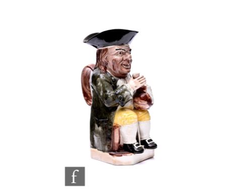 A Ralph Wood toby jug, modelled seated with foaming ale jug and ale glass, tricorn hat, grey/green coat and mustard yellow br