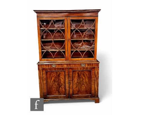 A late 19th Century mahogany bookcase in the Georgian style, enclosed by a pair of swept helix glazed bar doors over a single