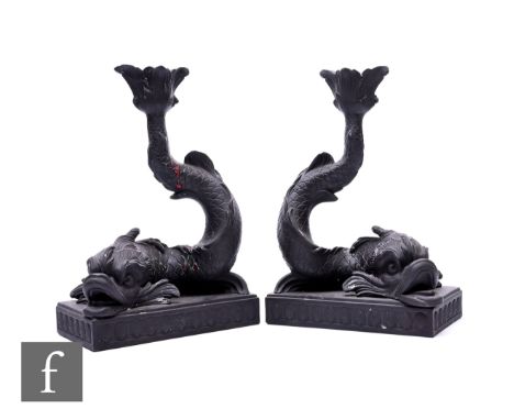 A pair of 20th Century Wedgwood black basalt candlesticks, modelled as dolphins with open mouths, incised fish scales and sin