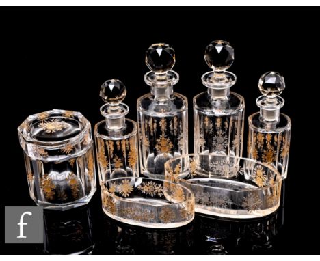 An early 20th Century cut glass dressing table set, decorated with panelled bodies with gilt painted cut floral decoration, c