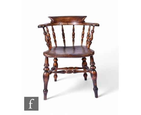 A 19th Century ash and elm smoker's bow elbow chair, on turned legs.