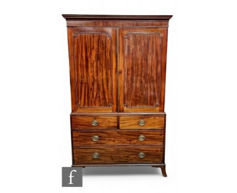 A George III mahogany linen press, the hanging space enclosed by a pair of re-entrant beaded edge doors below a fluted cornic