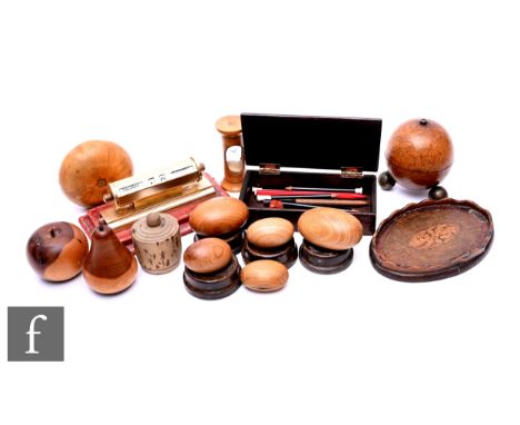 Assorted carved wooden fruit table ornaments, an hour glass, a miniature tray, an apothecary scales case and a desk calendar.