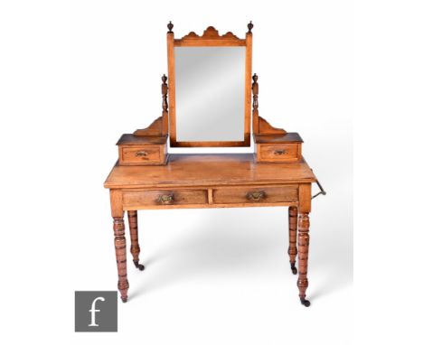 A late Victorian walnut mirror back dressing table fitted with two trinket drawers and two short drawers on turned legs and c