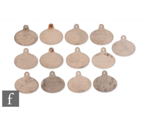 A set of thirteen Victorian bisque porcelain wine bin labels of shaped oval form, stamped 'No. 12, Maw &amp; Co Patent Bentha