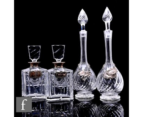 A pair of later 20th Century clear crystal decanters of shouldered rectangular section with flared facet stoppers, each with 