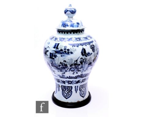 A large Dutch Delft chinoiserie jar and cover in the style of Samuel van Eenhoorn, of inverse baluster form, underglaze blue 