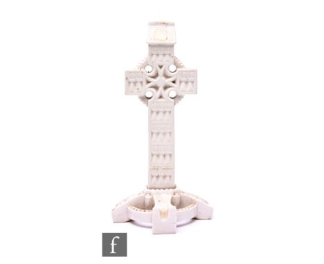 A Belleek model of a Celtic Cross, originally a holy water font but lacking bowl, black printed marks, height 31.5cm.