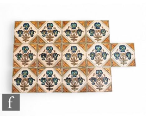 Gibbons, Hinton &amp; Co, a set of thirteen 6 inch dust pressed tiles, impressed hexagonal panel decorated with blue violas o